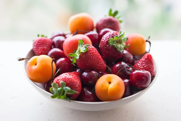 Assorted colorful fresh summer berries and fruits - apricots, ch — Stock Photo, Image