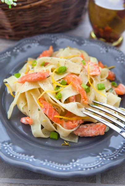 Pasta with smoked salmon and lemon zest — Stock Photo, Image