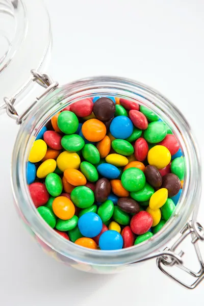 Colored candy in a glass jar — Stock Photo, Image