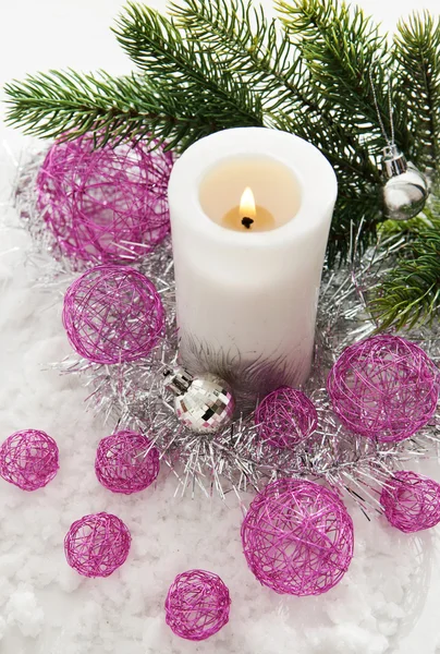 White candle and Christmas decorations around — Stock Photo, Image