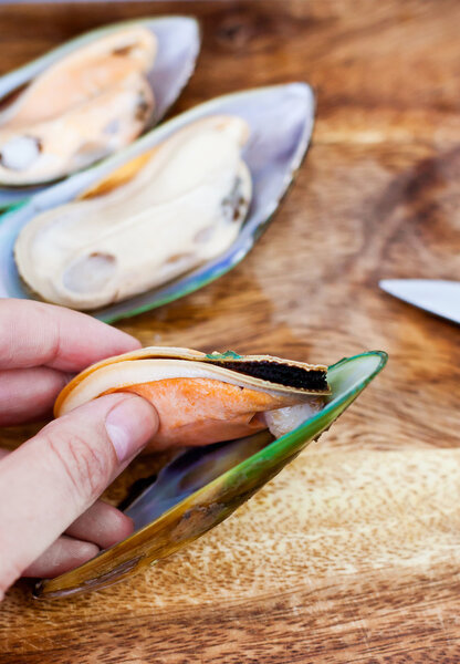 Raw giant mussels cutting process