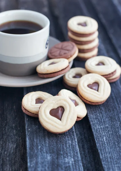 Cup of coffee and heart shaped cut out cookies — Stock Photo, Image