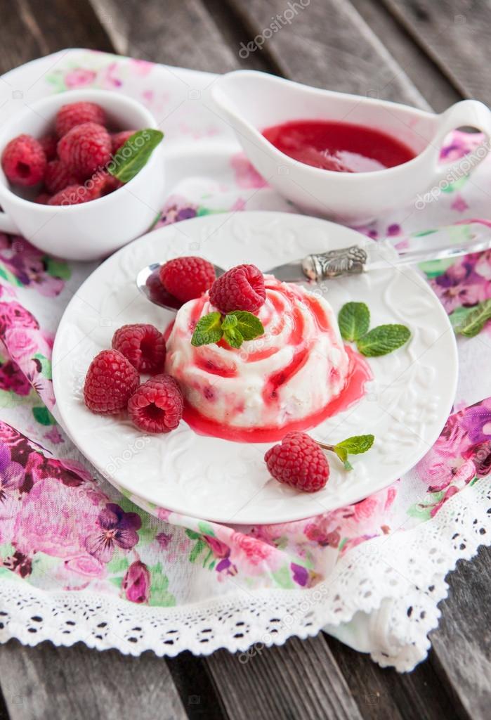 Delicious dessert with raspberry sauce and fresh berries