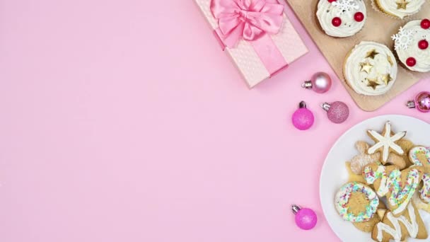 圣诞节与姜饼饼干和纸杯蛋糕的安排以粉红的粉红为主题 停止运动 — 图库视频影像