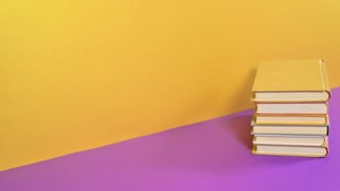 Altın turuncu temalı bir yığın kitap görünüp kayboluyor. Hareketi durdur