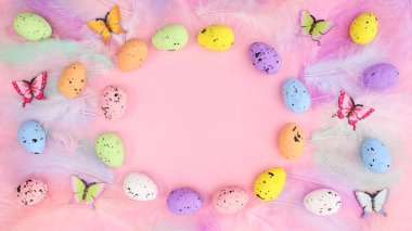 Paskalya yumurtaları çerçevesi ve tüyleri olan zarif yaratıcı fotokopi alanı pembe arka planı. İlkbahar yaratıcı düz yatak düzenleme.