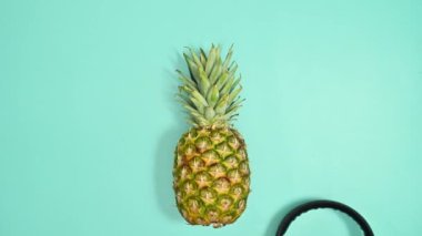 Creative pineapple appear, put sunglasses and headphones and start dancing. Stop motion