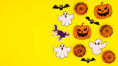 Creative yellow background with copy space and Halloween stickers. Flat lay