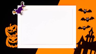 Halloween background with copy space in frame and scary stickers on orange and black background. Flat lay