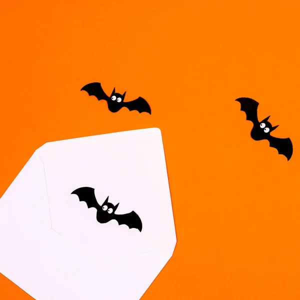 Halloween orange background with bats fly out from envelope. Creative idea. Autumn holidays concept