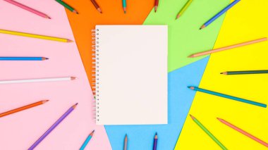 Copy space background with ope notebook and colorful pencils. Flat lay Back to school or art concept