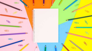 Copy space background with ope notebook and colorful pencils. Flat lay Back to school or art concept