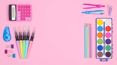 Creative copy space back to school backgorund. School stationery on pastel pink teme. Flat lay