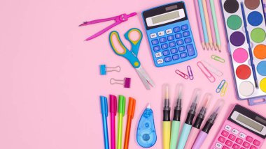 Creative back to school  copy space layout with school stationery on pastel pink background. Flat lay concept