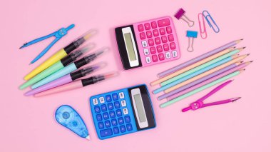 Creative back to school layout with school stationery on pastel pink background. Flat lay concept