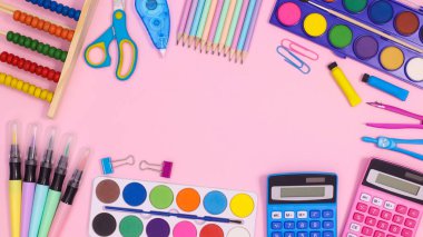 Creative copy space frame with Back to school stationery on pastel pink background. Flat lay