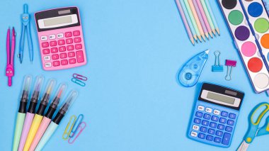 Back to school copy space backgroundwith school stationery on pastel blue theme. Flat lay
