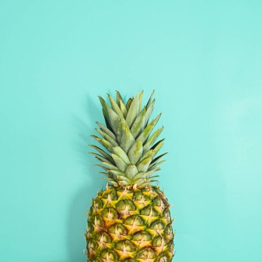 Fresh ripe pineapple on pastel blue background. Flat lay summer concept. Minimal