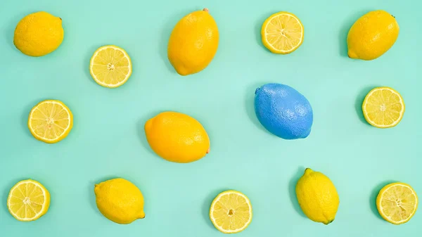 Summer lemons pattern on cyan background. Tropic fruits concept. Flat lay