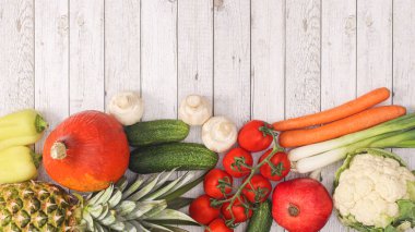 Wooden background with copy space and fresh fruits and vegetables. Flat lay healthy food concept