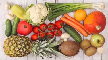 wooden table with fruits and vegetables arrangement. Flat lay healthy food concept