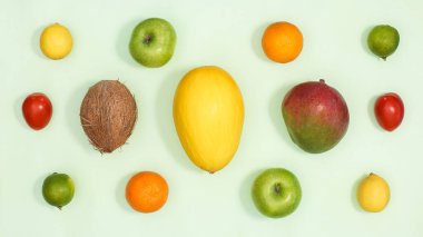 Summer exotic fruits pattern on bright green background. Flat lay