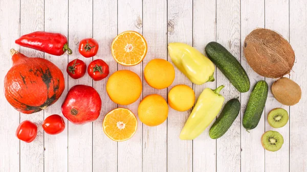 Creative layout with summer fresh fruits and vegetables on wooden background. Flat lay