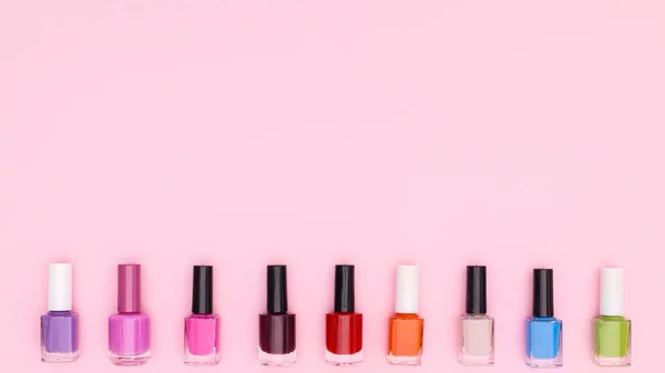 Colorful Nail Polish Bottles Pastel Pink Background Flat Lay Copy — Stockfoto