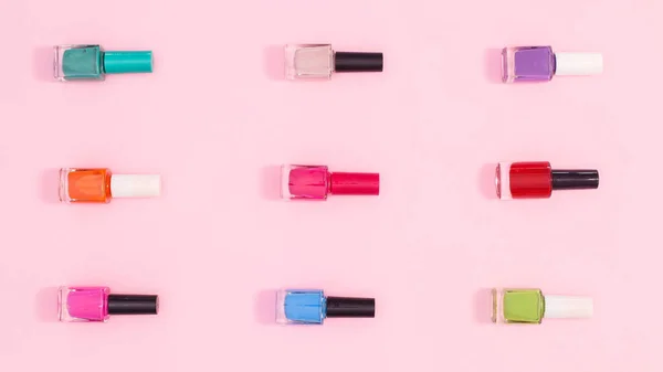 Nail Polish Bottles Various Colors Make Patern Pastel Pink Background — Stockfoto