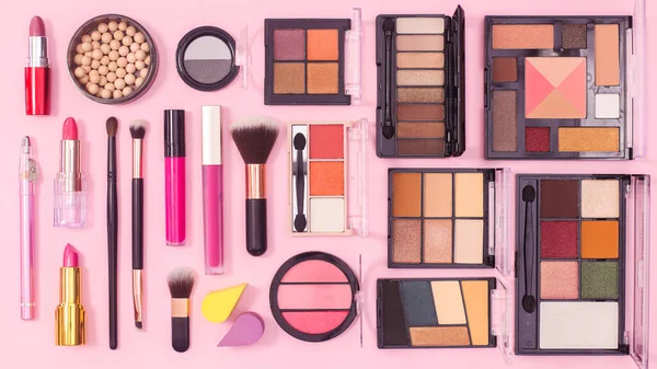 Make up products pattern on pink background. Flat lay