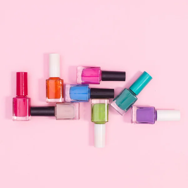 Creative Composition Nail Polish Bottles Various Colors Pastel Pink Background — Stockfoto