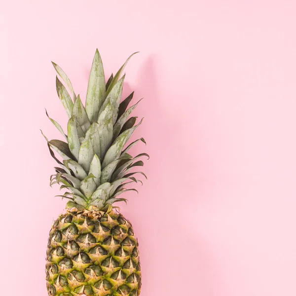 Fresh pineapple on on bright pink background. Flat lay