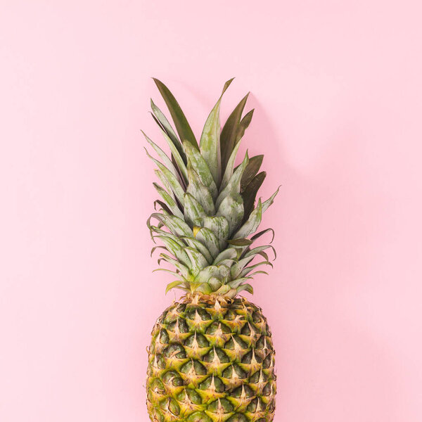 Fresh pineapple on on pastel pink background. Flat lay