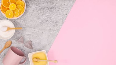 Tea ingredients on pastel pink background. Flat lay