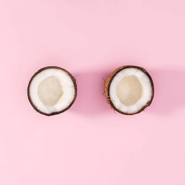 One Coconut Broken Two Peaces Pastel Pink Background Flat Lay — Stockfoto