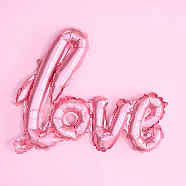 Love balloon for Valetine's day holidays o pastel pink background. Flat lay