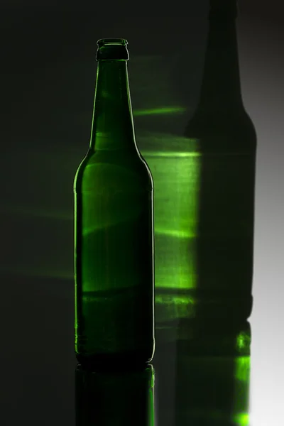 Green bottle with colored reflection — Stock Photo, Image