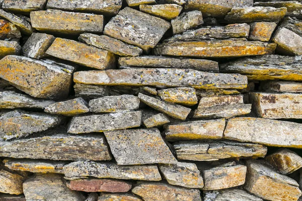 Ancient natural stone wall pattern closeup Stock Photo