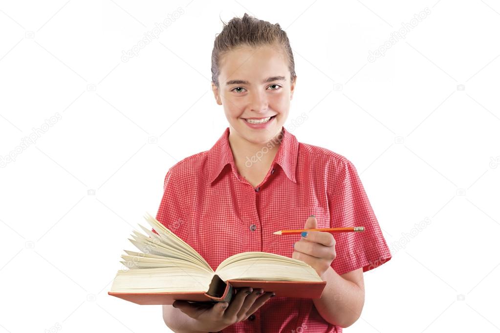 teenage girl with book and pencil in here hands, smiling into ca