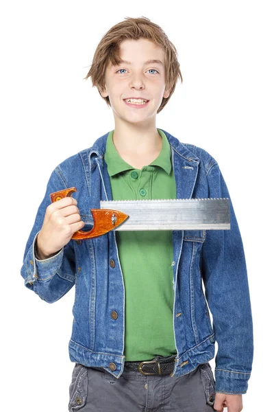 Confident teenage boy holding a saw in one hand, isolated on whi — Stock Photo, Image