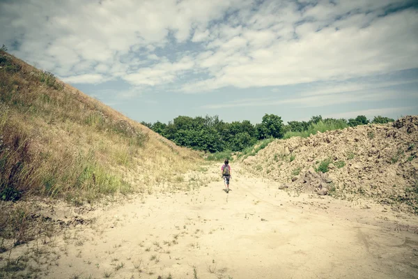Desierto como paisaje con la espalda de un niño caminante — Foto de Stock