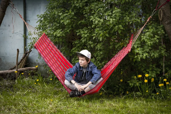 Cool teenager boy having a break in a hammock — Stock Photo, Image