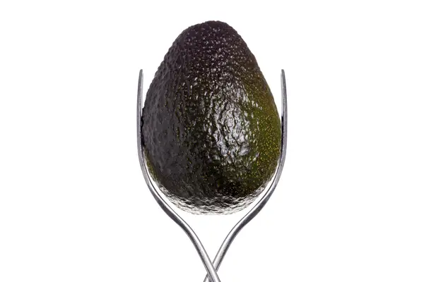 Avocado tussen twee vorken, geïsoleerd op wit — Stockfoto