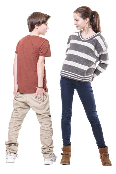 Two teenager, male and female smiling at each other, isolated on — Stock Photo, Image