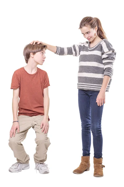 Two teenager, sister makes his brother smaller, isolated on whit — Stock Photo, Image