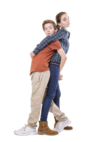 Teenager siblings hugging back on back, isolated on white — Stock Photo, Image