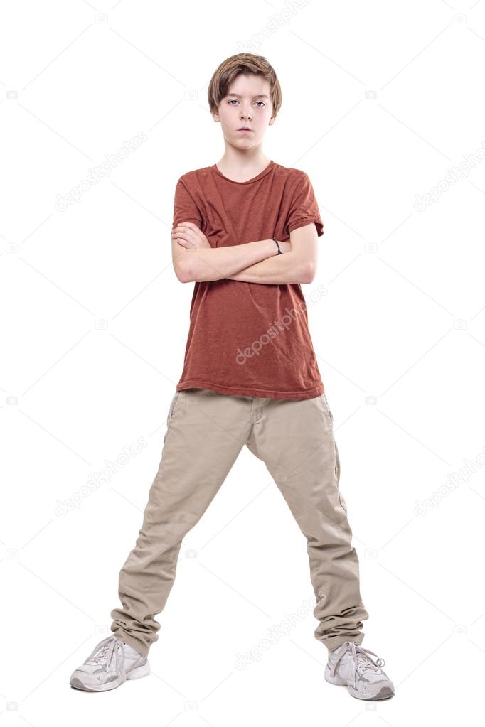 serious male teenager standing with crossed arms, isolated on wh