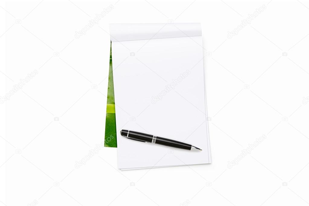 open blank note pad with ball pen and green cover, isolated on w