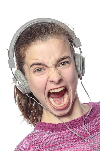 Keen  shouting female teenager with headphones, isolated on whit — Stock Photo, Image