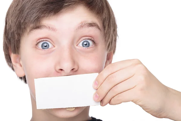 Portrait of a teenage boy holding a white piece of cardboard in — Stock Photo, Image